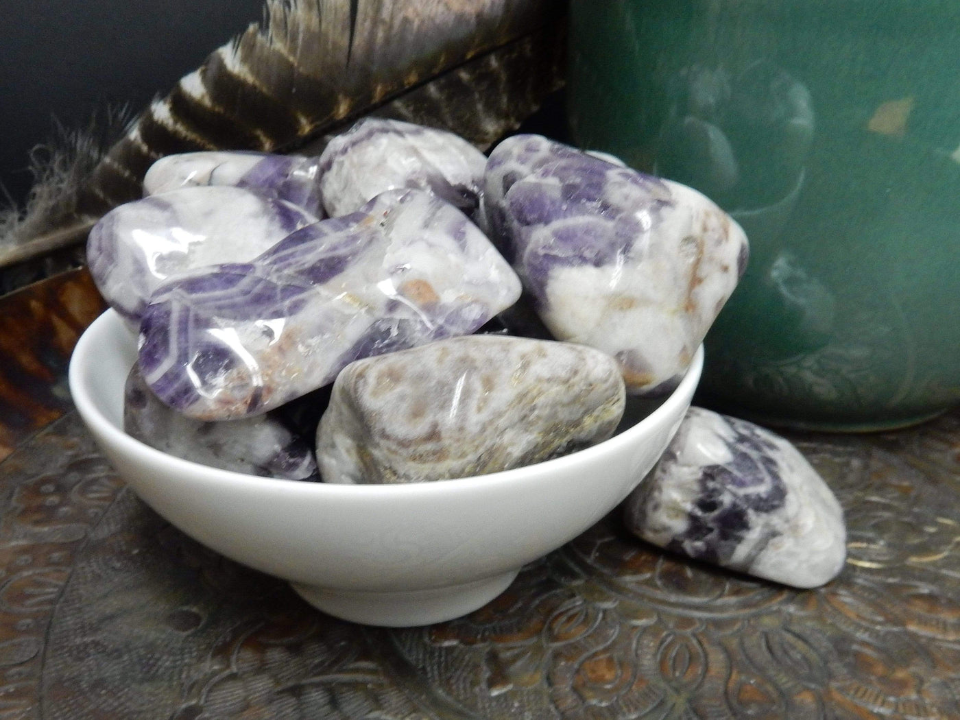 bowl of tumbled chevron amethyst with decorations in the background