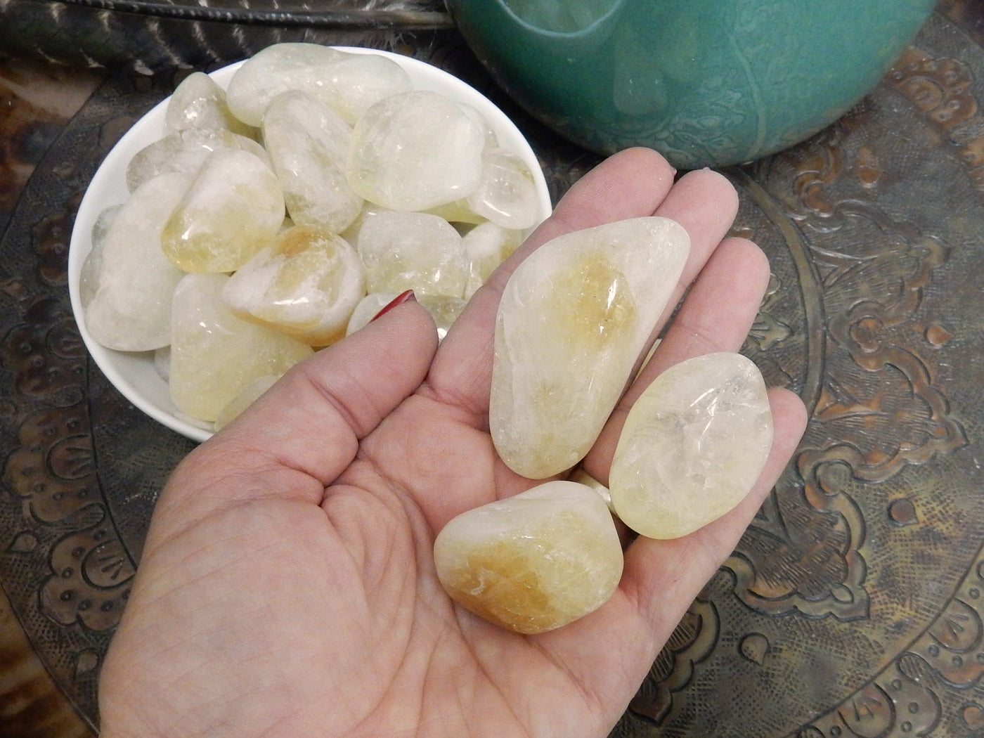 3 Citrine Tumbled Gemstones in hand to show size 