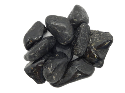 Natural Large Black Tourmaline Tumbled - a bunch on a table