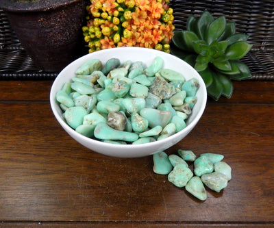 Bundle of Petite Tumbled Chrysoprase Gemstones in a white bowl on a wood table 