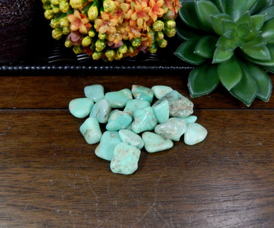 Bundle of Petite Tumbled Chrysoprase Gemstones on wood table 