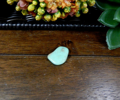 Single Petite Tumbled Chrysoprase Gemstone on wood table 