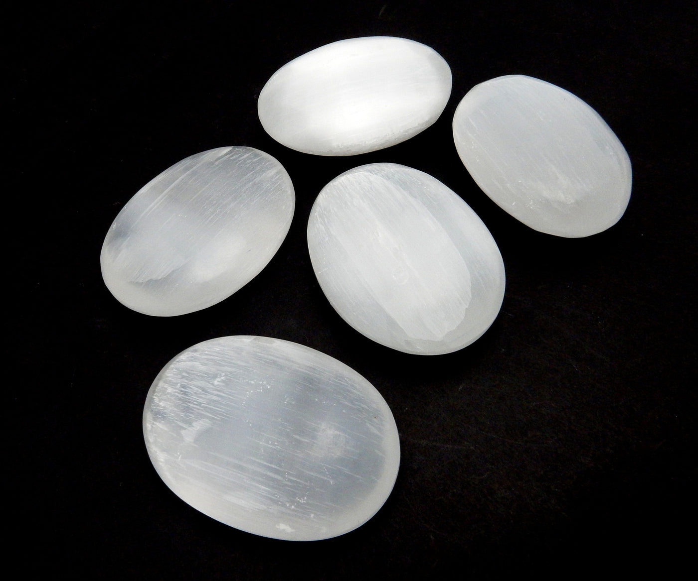 angled view of selenite palm stones