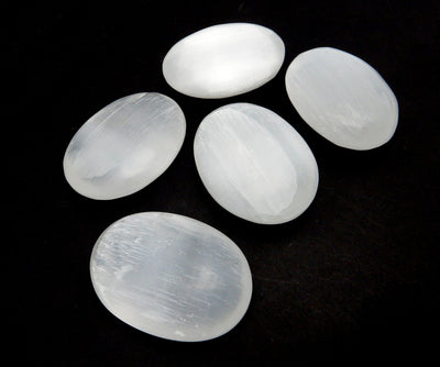 angled view of selenite palm stones