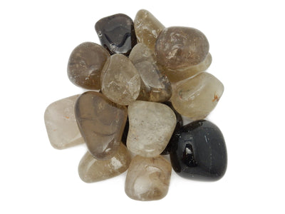 overhead view of many smokey quartz tumbled gemstones in a pile