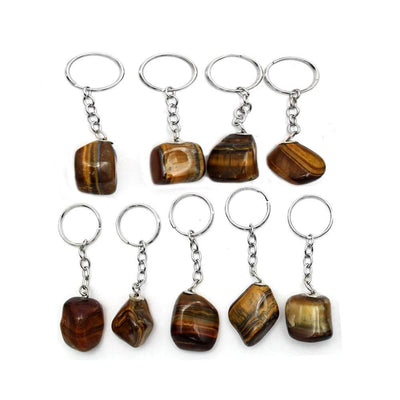 multiple tumbled tigers eye keychain displayed to show the differences in the sizes 