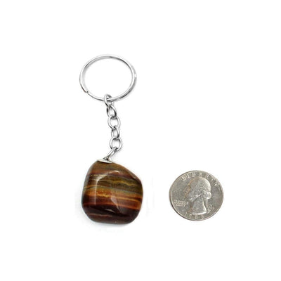 tigers eye keychain next to a quarter for size reference 