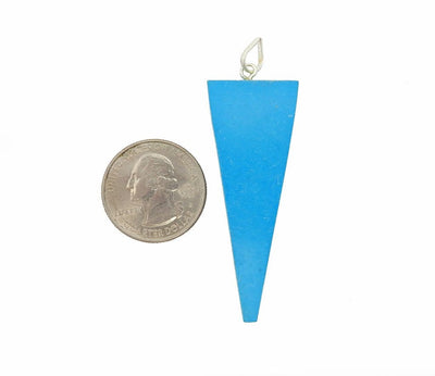 Turquoise Pendant displayed next to quarter for size reference
