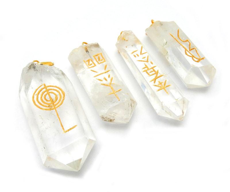 4 Piece Set Usui Reiki Crystal Quartz Point Pendant Set with Gold Tone Bail from an angled view 