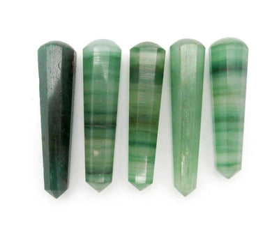 multiple green fluorite wands displayed next to each other to show the differences in the color shades 