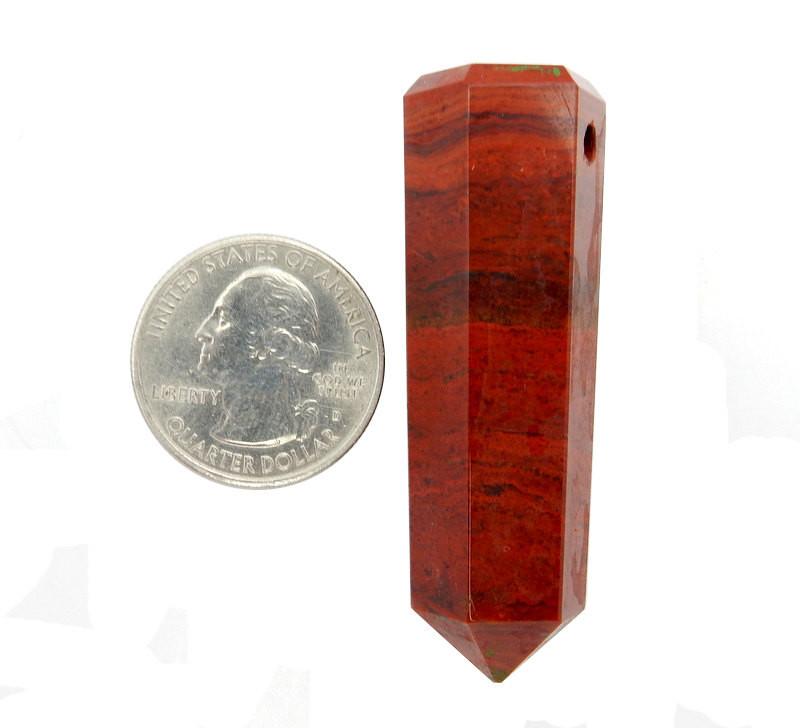 Red Jasper Tower Obelisk Point next to a quarter for size reference on white background