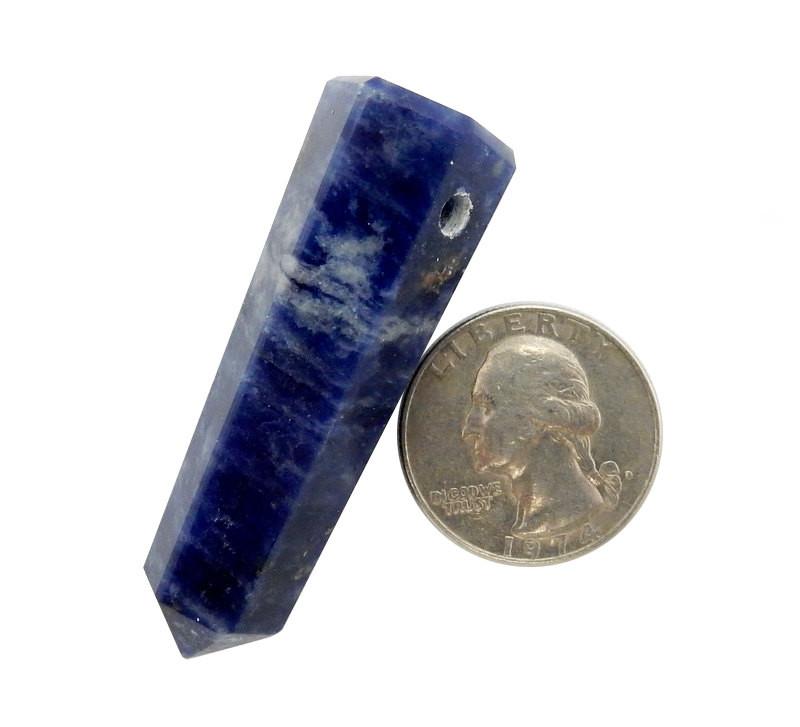 drilled sodalite obelisk point next to a quarter for size reference