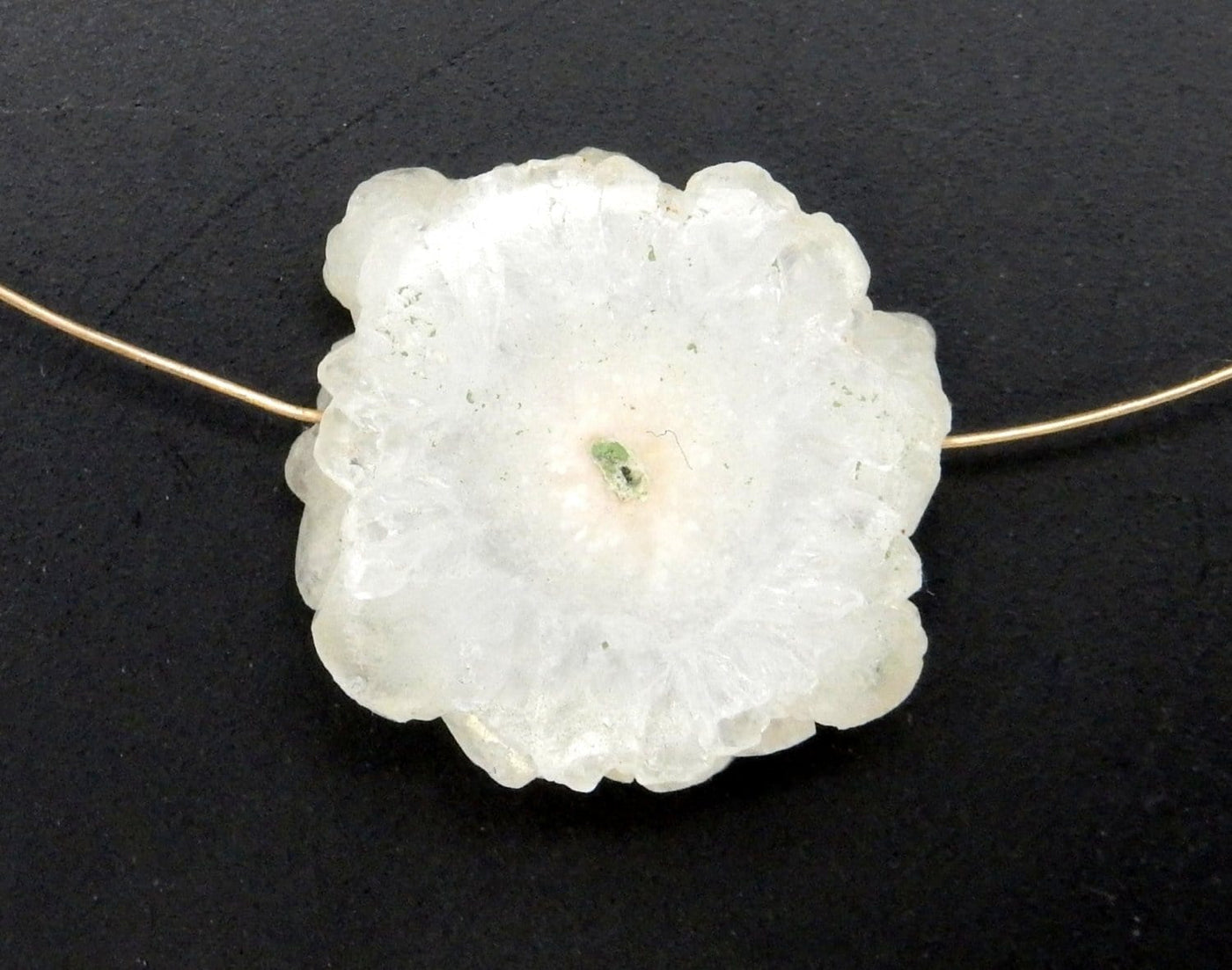 White Solar Quartz Side Drilled Bead  with gold wire through it displaying drilled style