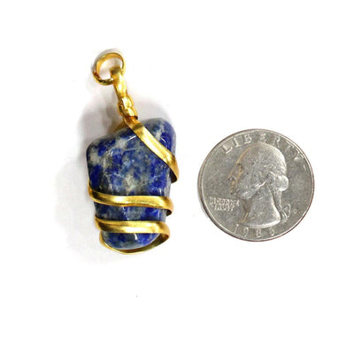 gold wire wrapped sodalite pendant next to a quarter for size reference 