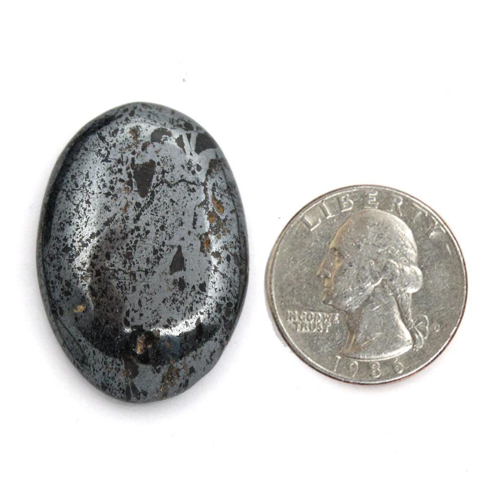Hematite Worry Stone Slab displayed next to quarter for size reference
