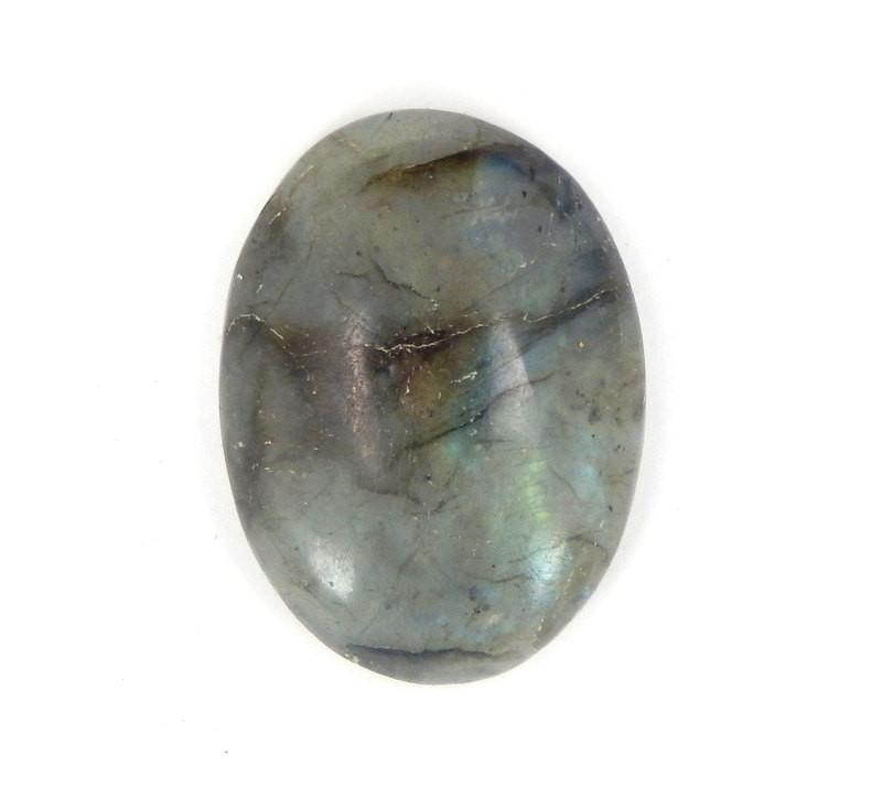 up close of labradorite thumb stone on white background