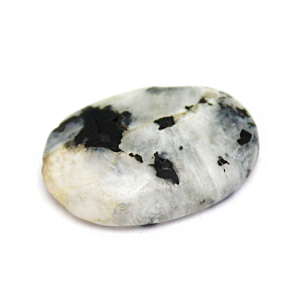 Moonstone worry stone it is white with black spots on a white background.