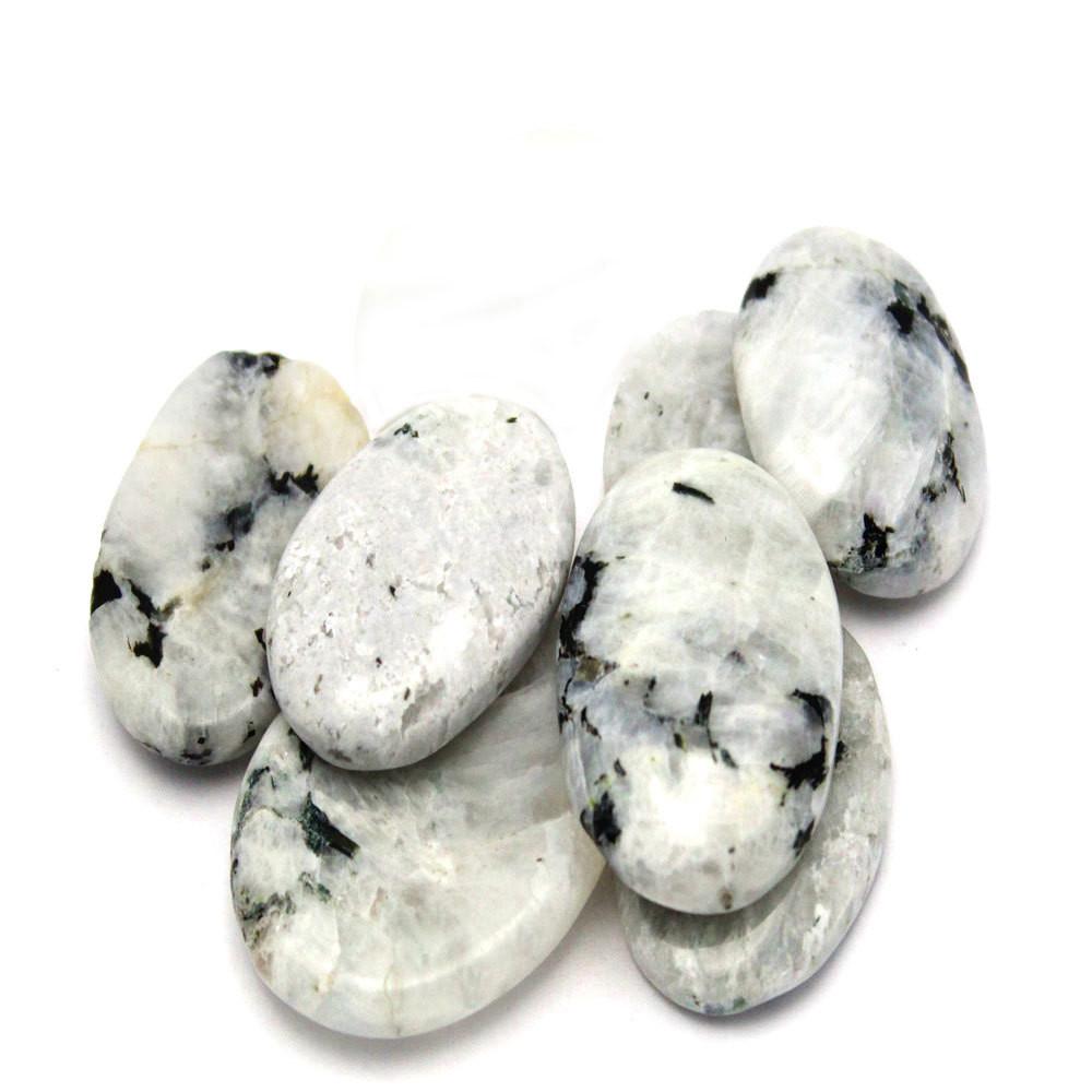 A stack of moonstone worry stones on a white background.