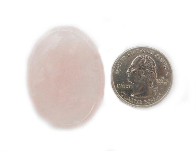 Rose Quartz Worry Stone Slab next to a quarter for size reference