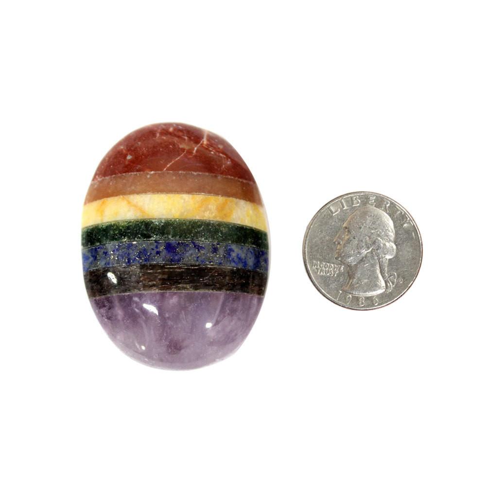 one seven chakra worry stone with quarter for size reference