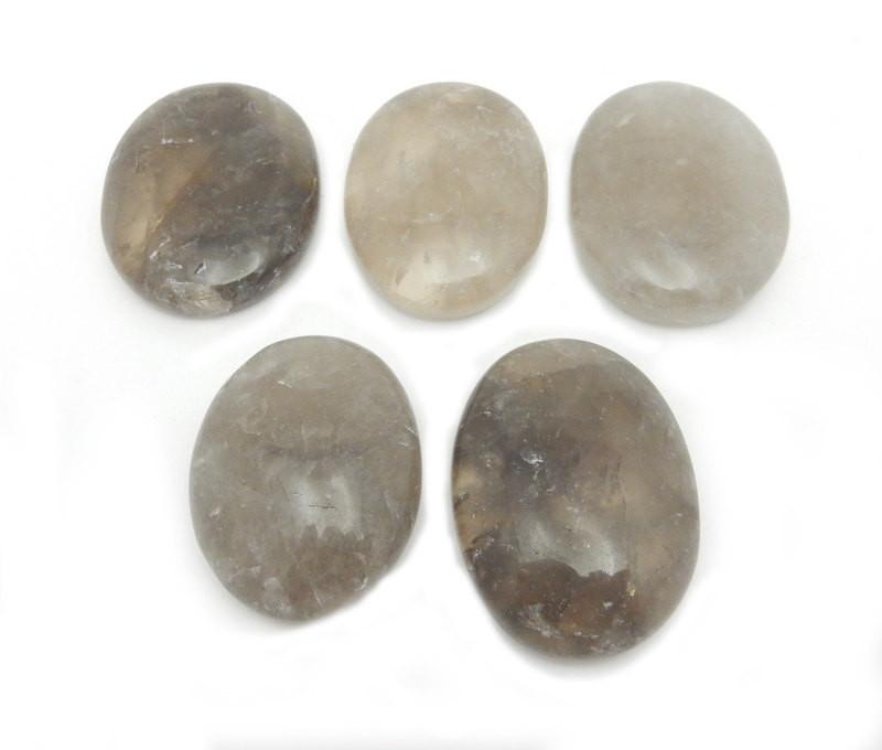 five smokey quartz worry stones on white background for possible variations