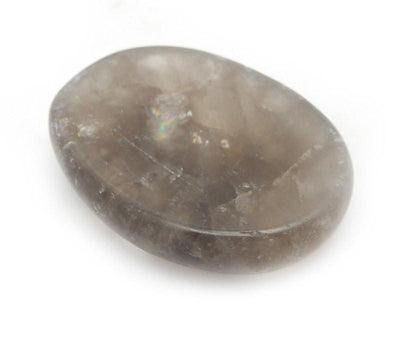 angled view of one smokey quartz worry stone on white background for thickness