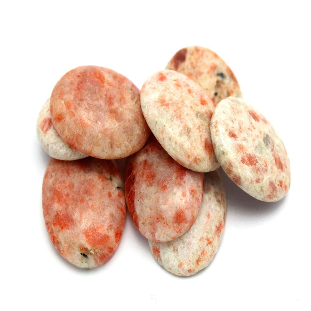 sunstone worry stones displayed on white background to show different characteristics 