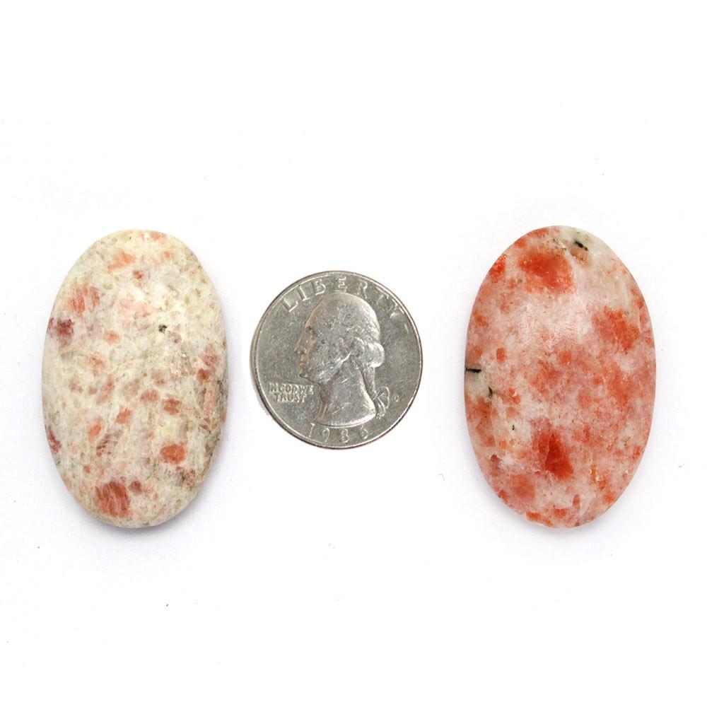 Worry Stones displayed next to a quarter for size reference