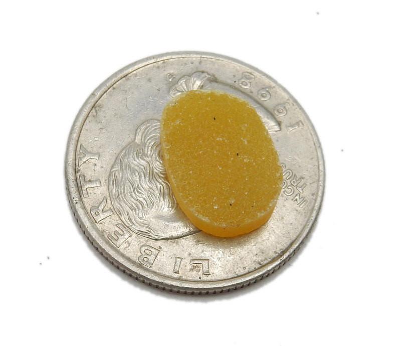 one  yellow druzy oval on a quarter