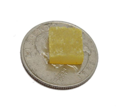 One yellow square druzy placed on a quarter to show it is smaller than the quarter.