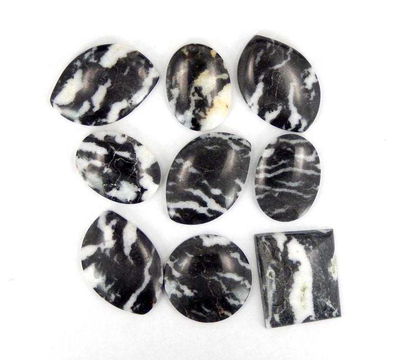 multiple zebra jasper cabochons displayed to show the differences in the sizes 