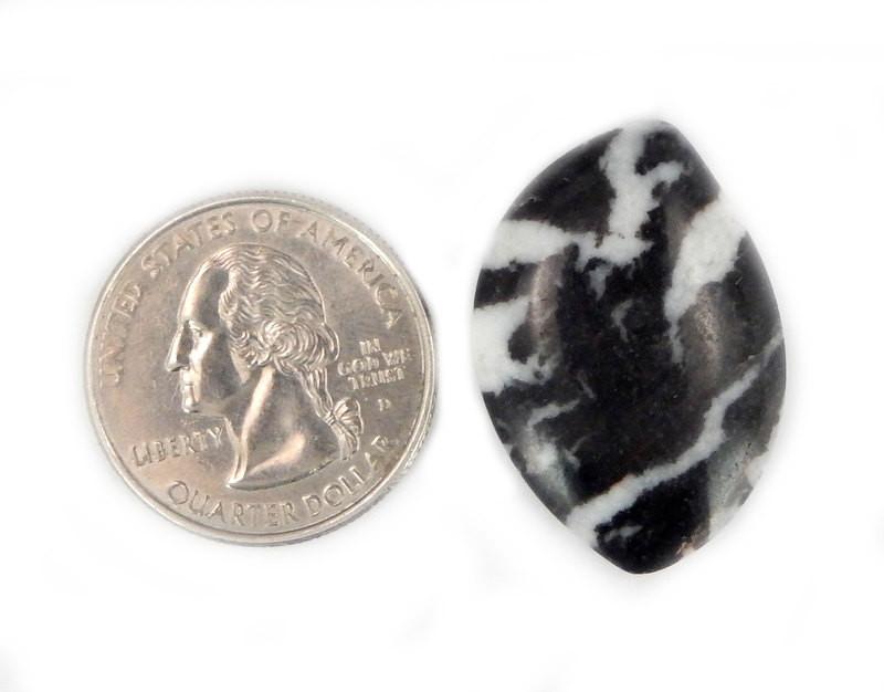 cabochon next to a quarter for size reference 